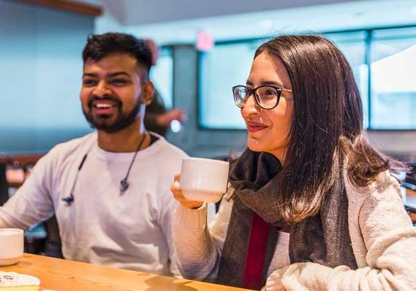 Two UBC students have a coffee in a UBC residence