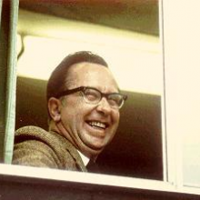 Peter Larkin smiling through a window
